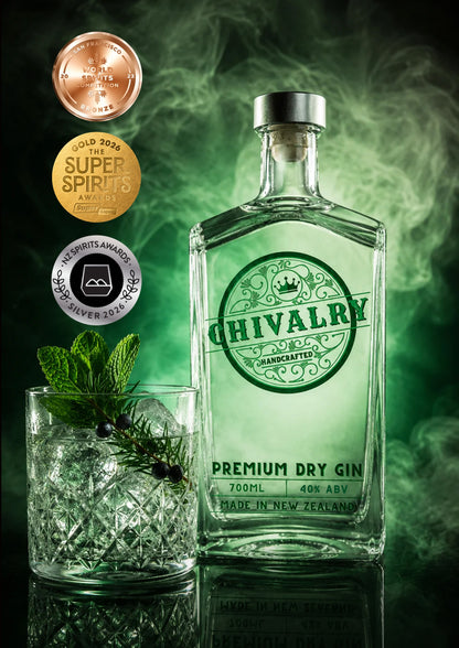 A bottle of Chivalry Premium Dry Gin stands on a reflective dark surface beside a glass of gin with ice, mint leaves, and a sprig of berries. The background is smoky green with award badges on the left: a bronze Best of Spirits award, a gold Super Spirits award, and a silver Spirits Awards award.