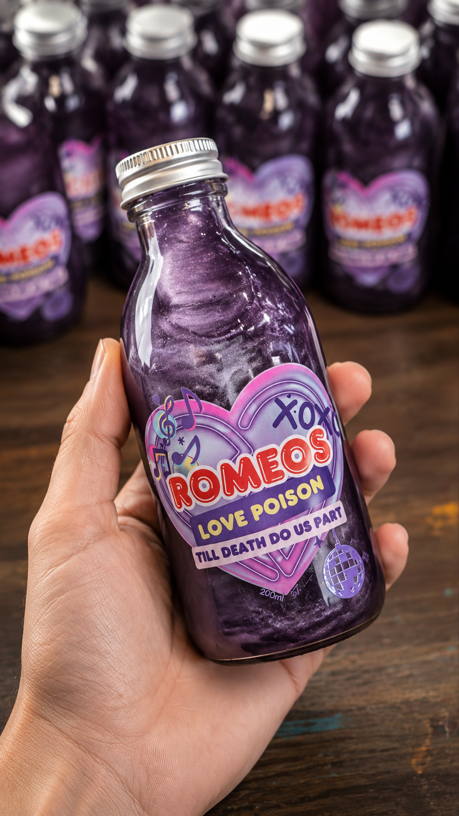 A hand holding a glass bottle of purple liquid labeled 'Romeo's Love Poison' against a background of multiple identical bottles on a wooden surface.