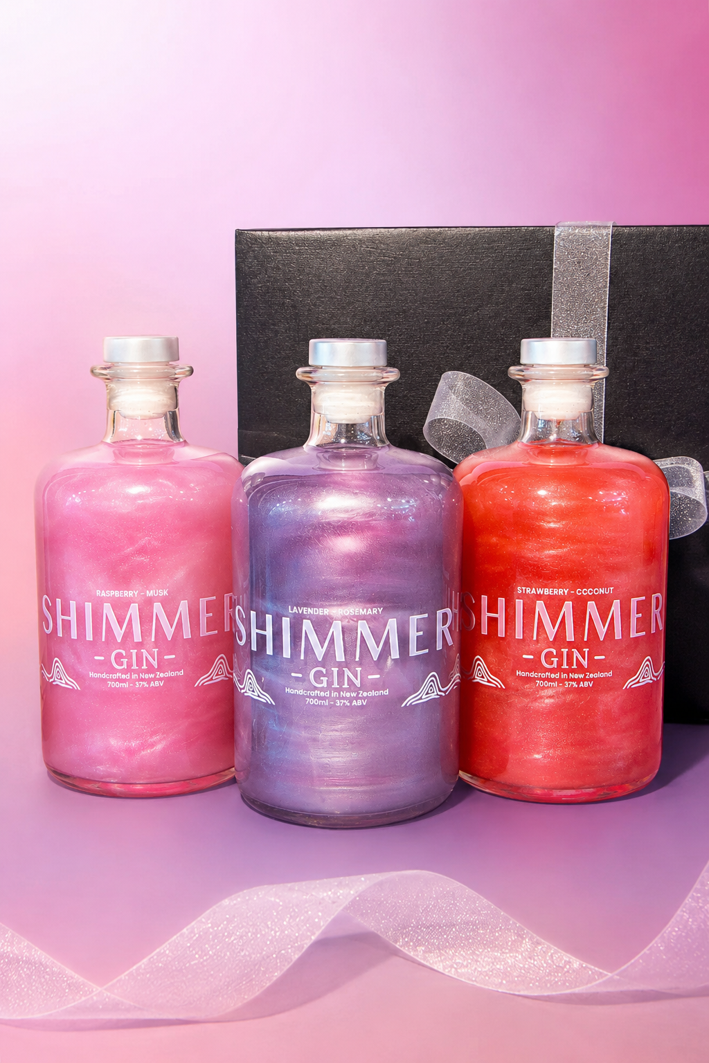 Three bottles of Shimmer Gin in pink, purple, and red on a pink background.