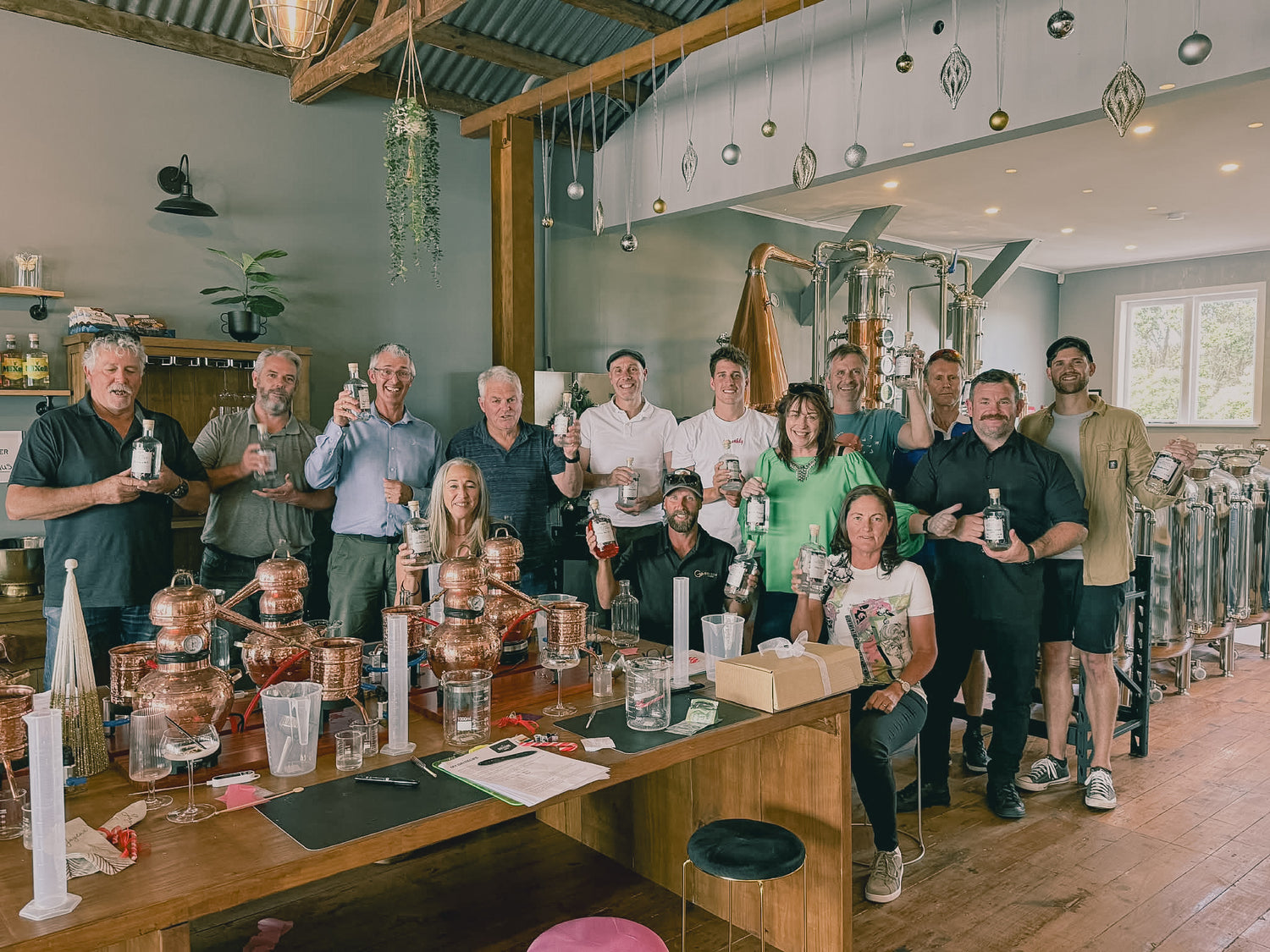 Group of people standing around a bar with drinks in a casual setting