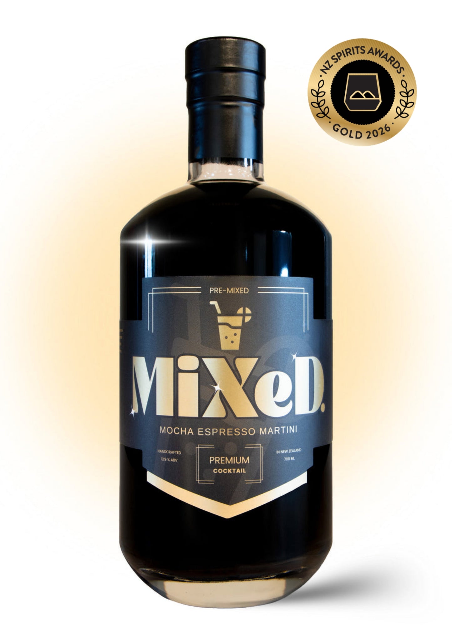 A bottle of Mixed. Mocha Espresso Martini pre-mixed cocktail mix, featuring a dark glass bottle with a black cap and a navy blue label with gold lettering.