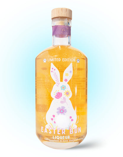 Bottle of Easter Bun liqueur with a decorative label on a light blue background